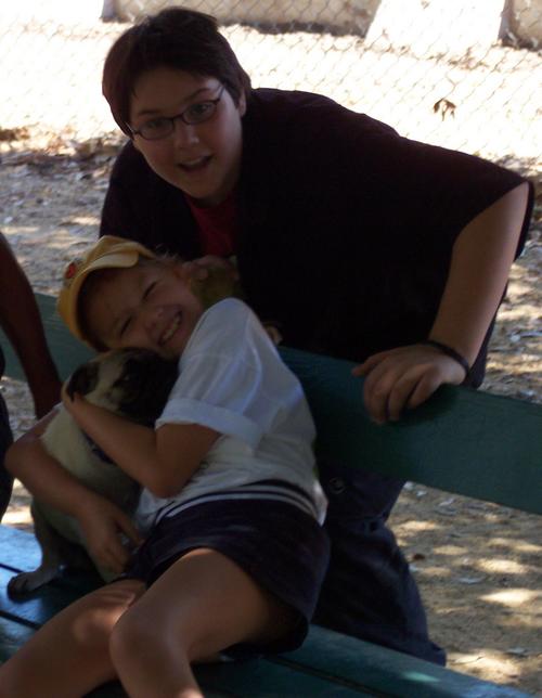 Adam and Julia hugging Sheba